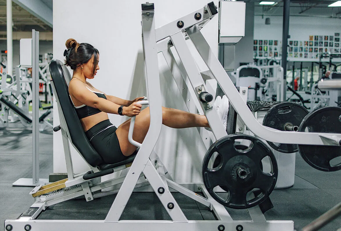 Woman using leg press machine