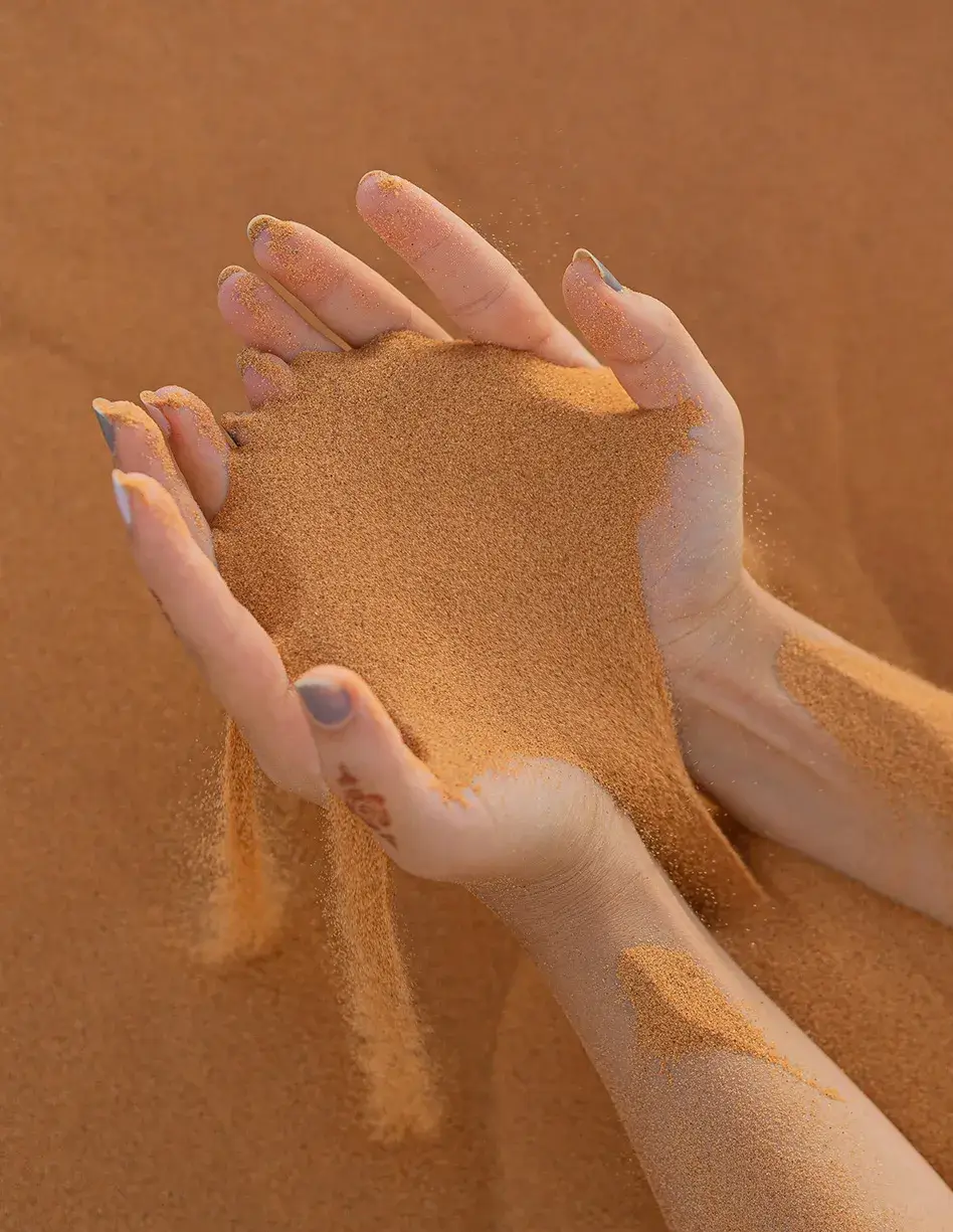 Hands holding sand