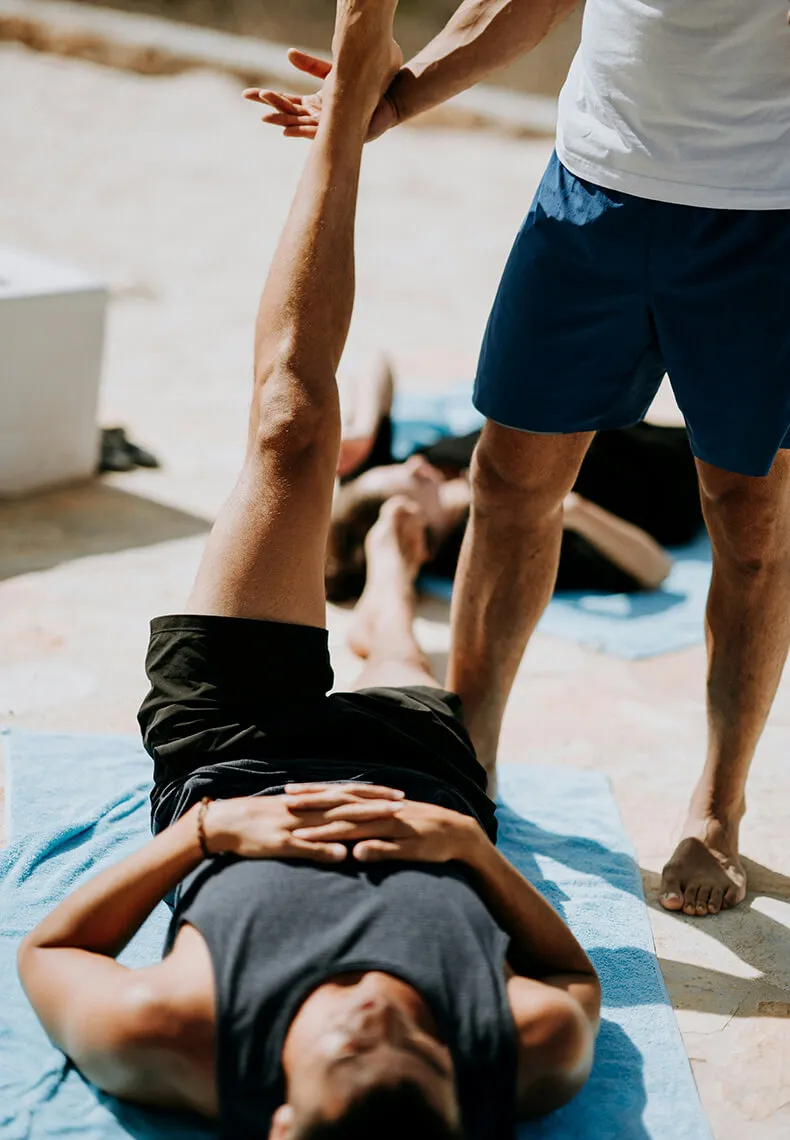 recovery specialist stretching man's leg